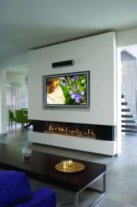a TV installed over a linear gas fireplace