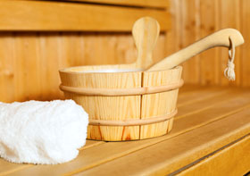 sauna bucket with towel and sauna scoop