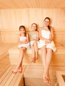 Mother with two daughters in sauna