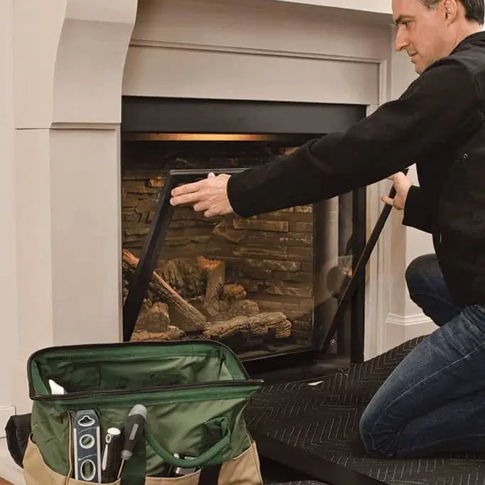 Serviceman servicing valor fireplace